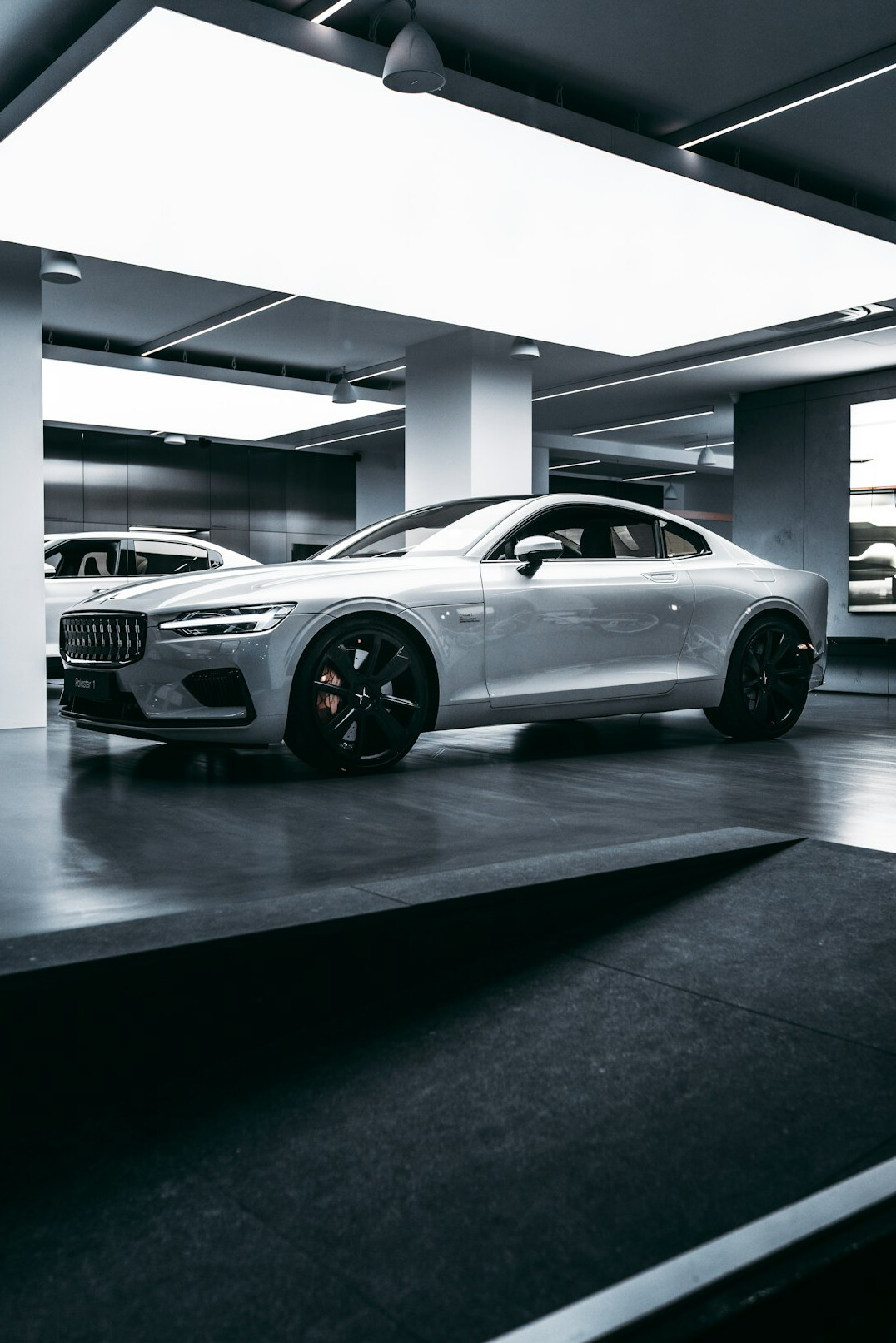 Sports car parked in front of a garage ready for inspection