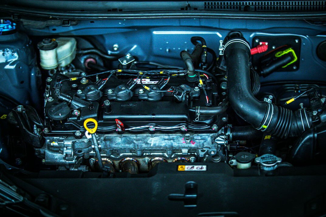 Close-up of tools and engine bay during a car check
