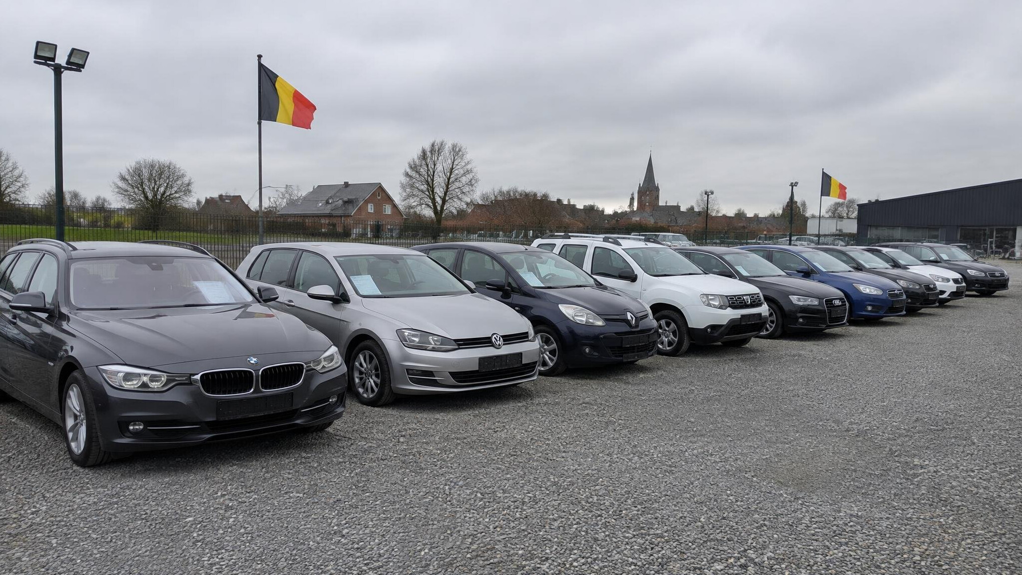 Row of used cars on a dealership lot